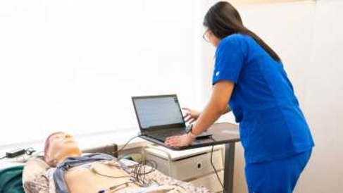 a person in blue scrub performing a ECG 